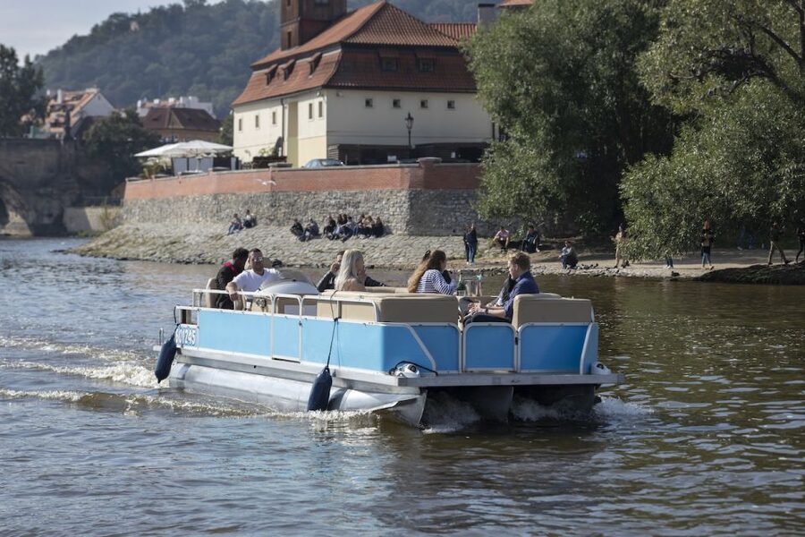 Prague: Beer Boat Tour - The onboard setup: bartender/captain, life vests, and easy comfort