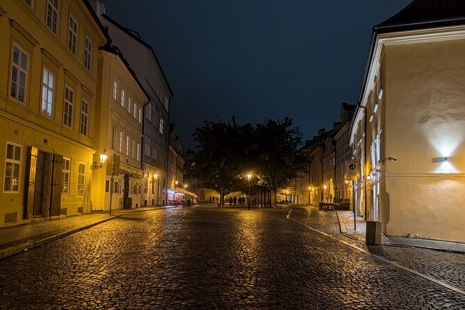 Prague by Night A Scenic Walk from Petrin Hill to Old Town - Charles Bridge after dark: statues, crowds, and a good-luck wish