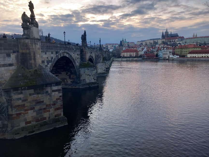 Prague: Unique Walking Tour with a Local Historian - Crossing Charles Bridge with a view of Prague Castle